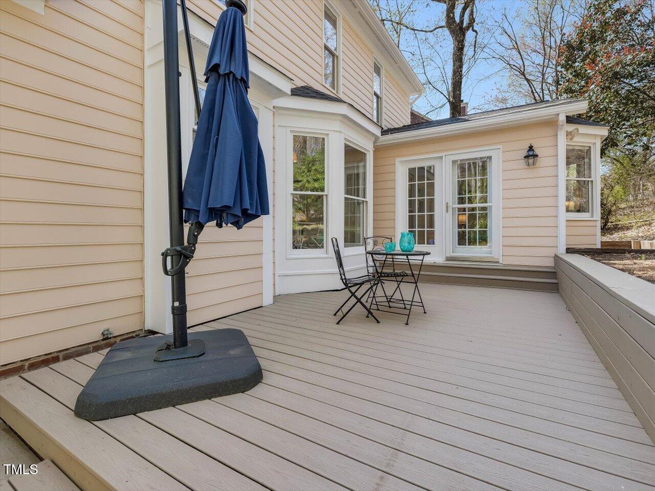 4818 Glendarion Drive Durham, NC 27713 - Photo 18 of 44 a view of a patio with table and chairs with wooden floor and fence