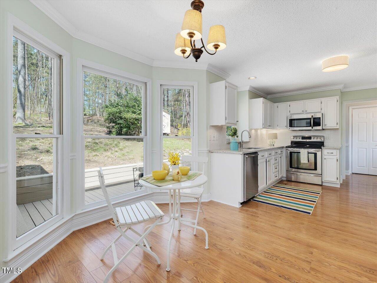 4818 Glendarion Drive Durham, NC 27713 - Photo 22 of 44 a living room with stainless steel appliances furniture and a table