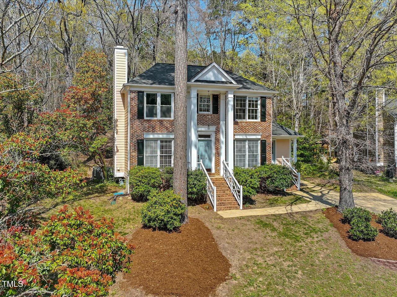 4818 Glendarion Drive Durham, NC 27713 - Photo 2 of 44 a front view of a house with a yard and potted plants