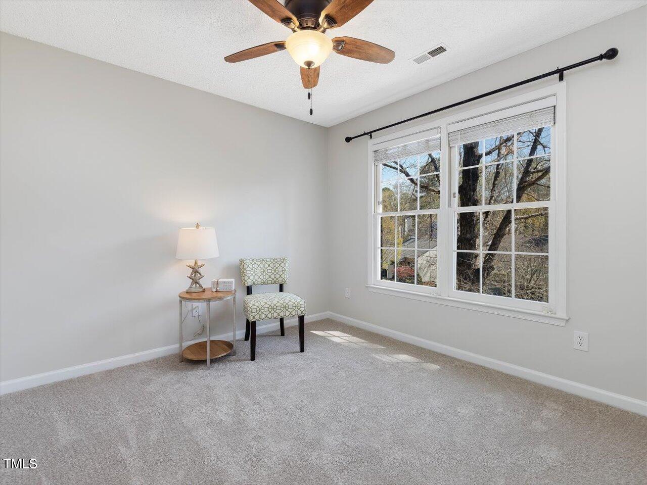 4818 Glendarion Drive Durham, NC 27713 - Photo 34 of 44 an empty room with chandelier fan and windows
