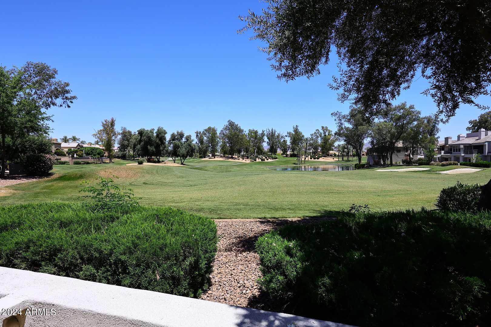 7272 East Gainey Ranch Road, Unit 55 Scottsdale, AZ 85258 - Photo 11 of 35 a view of a grassy field with trees