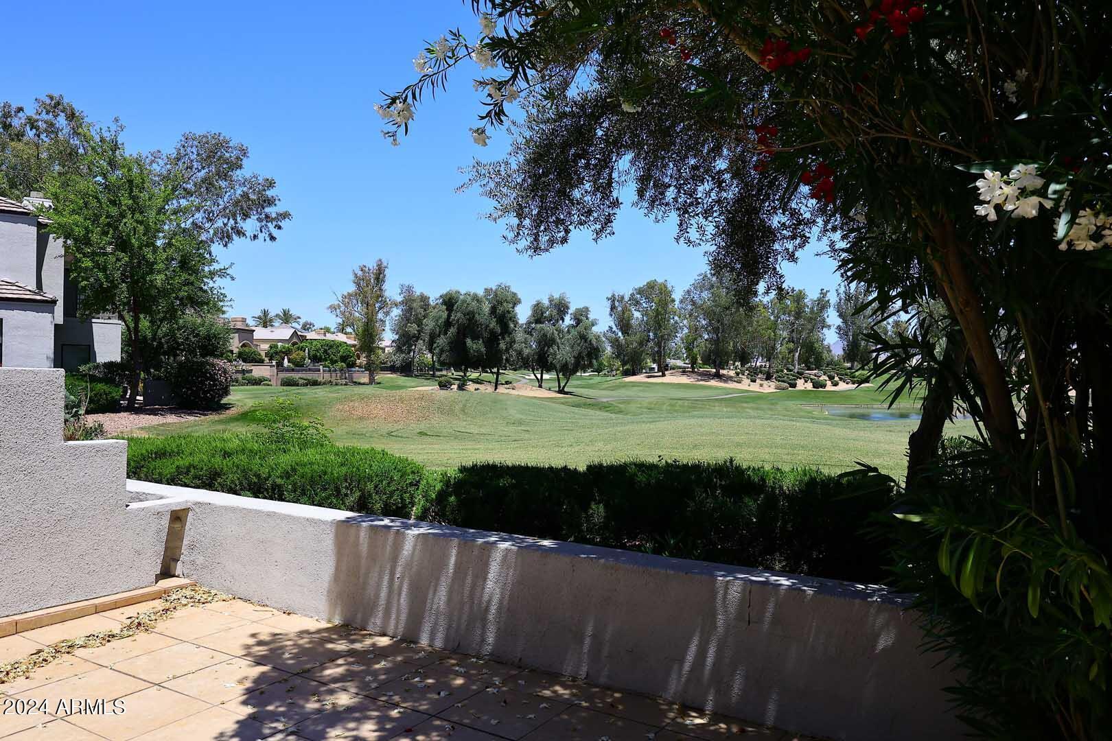 7272 East Gainey Ranch Road, Unit 55 Scottsdale, AZ 85258 - Photo 13 of 35 a view of a golf course with a lake view