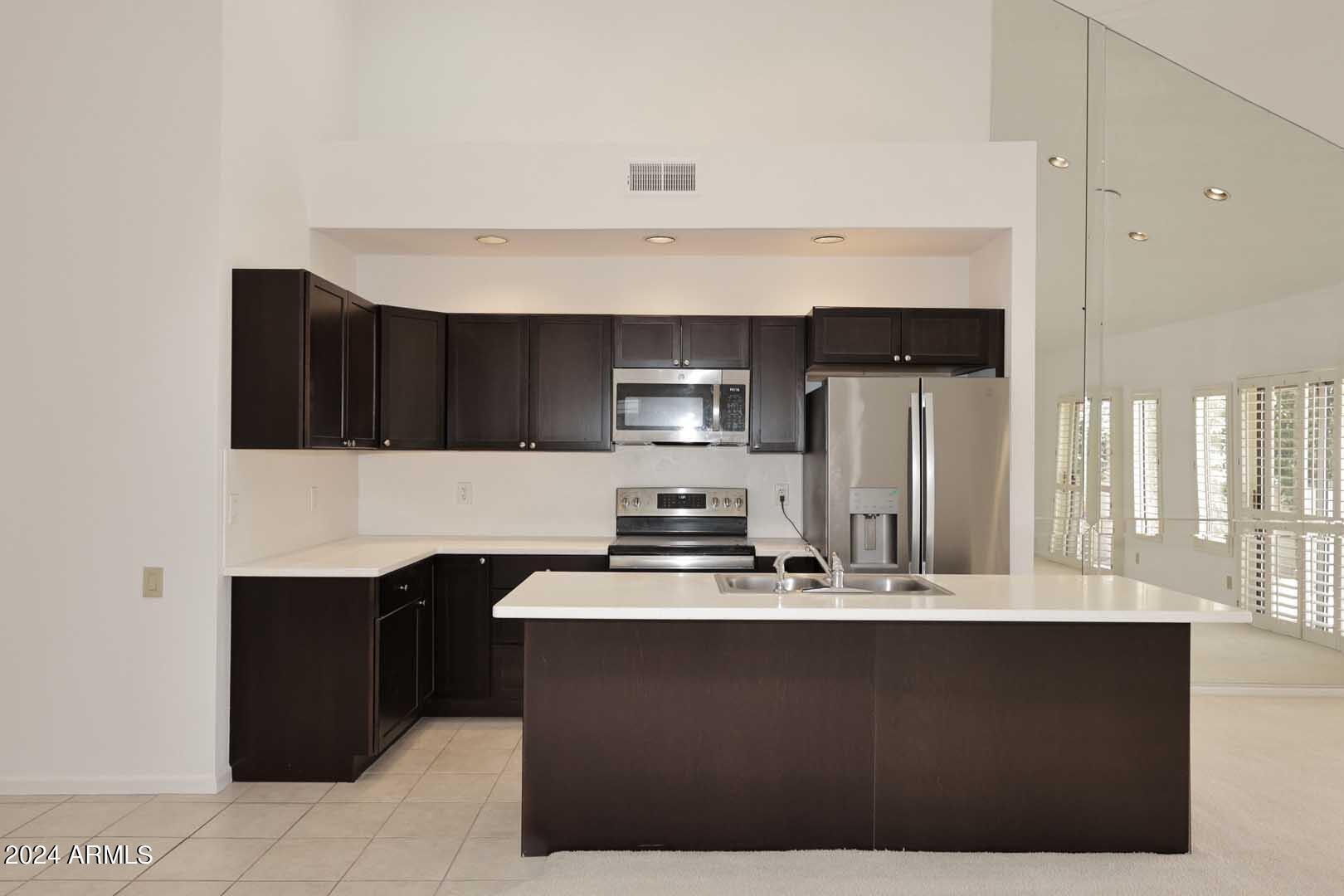 7272 East Gainey Ranch Road, Unit 55 Scottsdale, AZ 85258 - Photo 16 of 35 a kitchen with a sink a stove and refrigerator