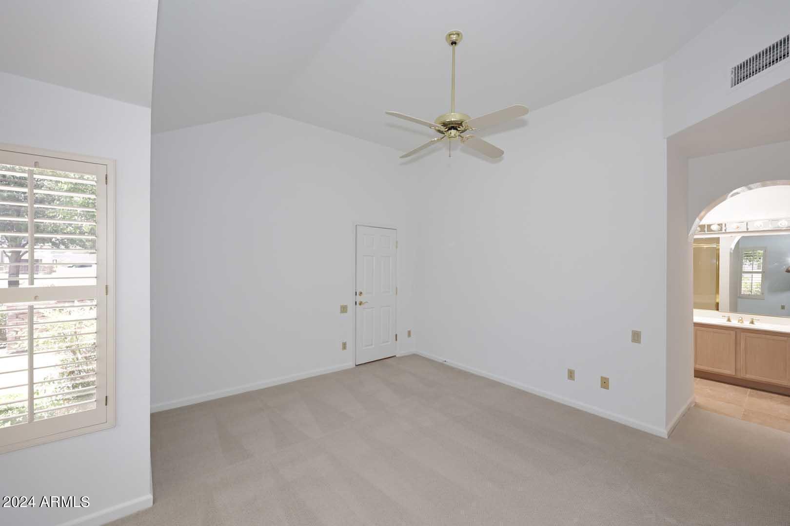 7272 East Gainey Ranch Road, Unit 55 Scottsdale, AZ 85258 - Photo 20 of 35 an empty room with windows and fan