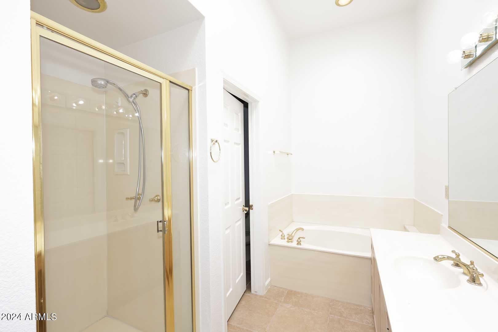 7272 East Gainey Ranch Road, Unit 55 Scottsdale, AZ 85258 - Photo 24 of 35 a bathroom with a bathtub and a shower