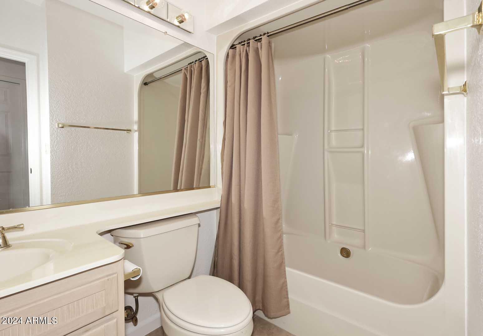 7272 East Gainey Ranch Road, Unit 55 Scottsdale, AZ 85258 - Photo 25 of 35 a bathroom with a toilet and a shower