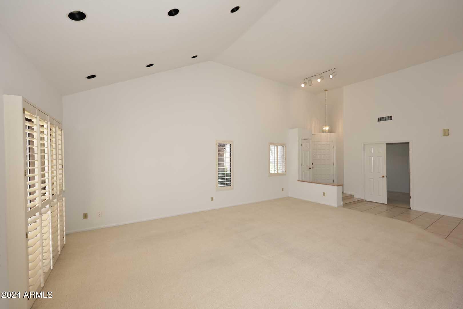 7272 East Gainey Ranch Road, Unit 55 Scottsdale, AZ 85258 - Photo 5 of 35 an empty room with closet and windows