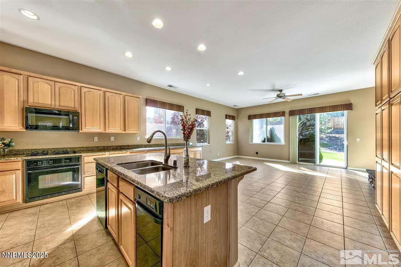 1830 Kodiak Circle Reno, NV 89511 - Photo 11 of 27 a kitchen with stainless steel appliances granite countertop a sink stove and cabinets
