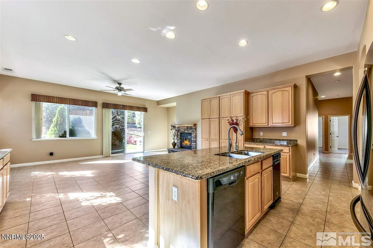 1830 Kodiak Circle Reno, NV 89511 - Photo 13 of 27 a kitchen with stainless steel appliances granite countertop a sink and a stove