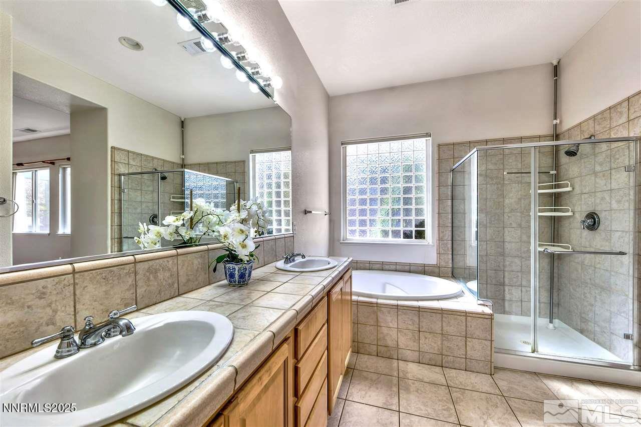 1830 Kodiak Circle Reno, NV 89511 - Photo 17 of 27 a bathroom with a granite countertop tub sink shower and mirror