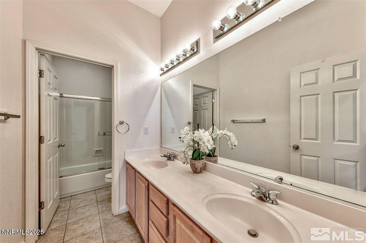 1830 Kodiak Circle Reno, NV 89511 - Photo 20 of 27 a bathroom with a double vanity sink mirror double and shower
