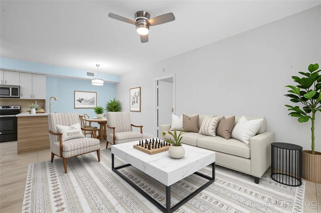 6401 Aragon Way, Unit 103 Fort Myers, FL 33966 - Photo 11 of 40 a living room with furniture a ceiling fan and a rug
