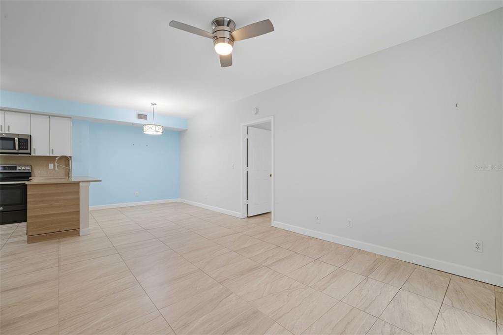 6401 Aragon Way, Unit 103 Fort Myers, FL 33966 - Photo 12 of 40 an empty room with a kitchen and a sink
