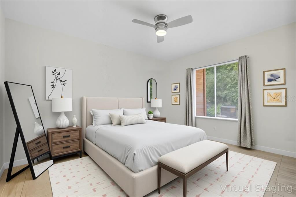 6401 Aragon Way, Unit 103 Fort Myers, FL 33966 - Photo 17 of 40 a bedroom with a bed a chandelier and dresser