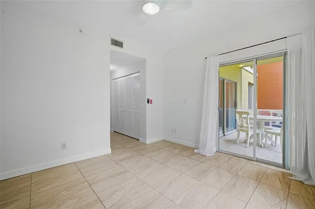 a view of a dining room with furniture large windows and wooden floor
