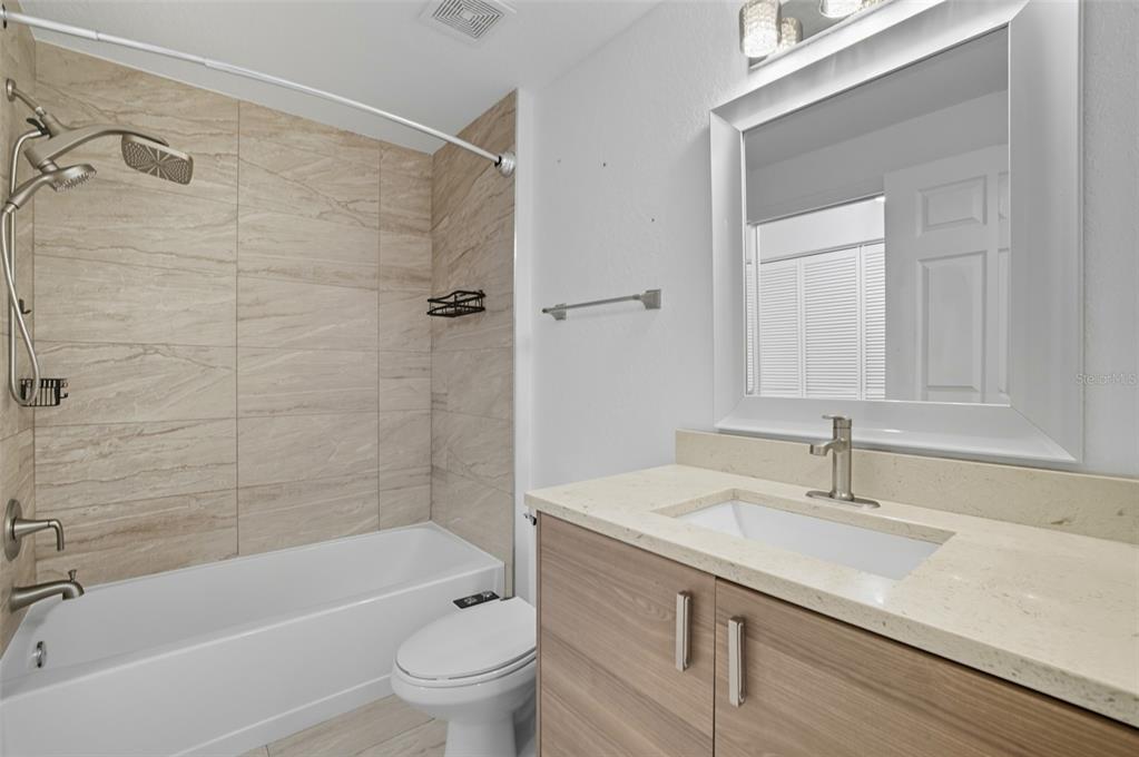 6401 Aragon Way, Unit 103 Fort Myers, FL 33966 - Photo 26 of 40 a bathroom with a sink a toilet and shower