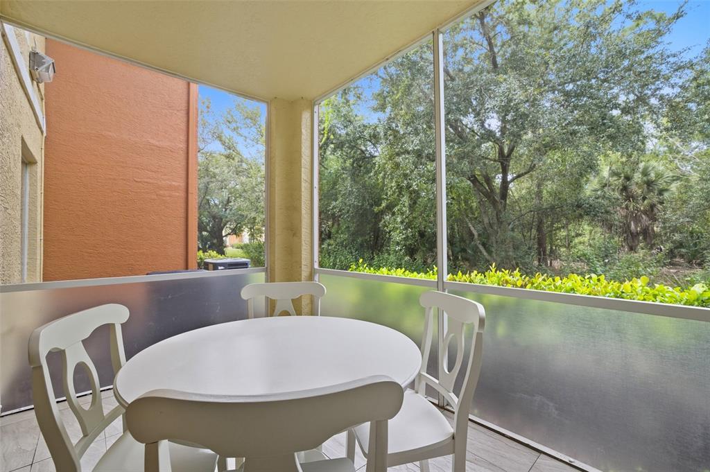 6401 Aragon Way, Unit 103 Fort Myers, FL 33966 - Photo 27 of 40 a view of a dining room with furniture large windows and wooden floor