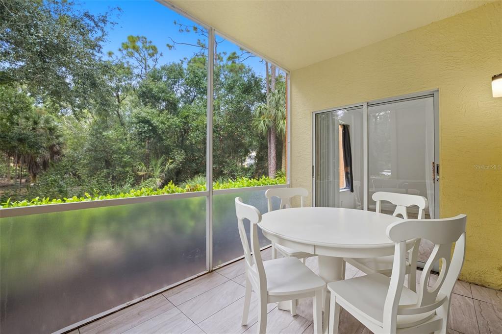 6401 Aragon Way, Unit 103 Fort Myers, FL 33966 - Photo 28 of 40 a view of an outdoor dining space with a lake view