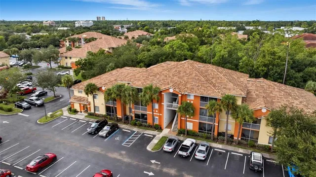 an aerial view of a house with a garden and trees