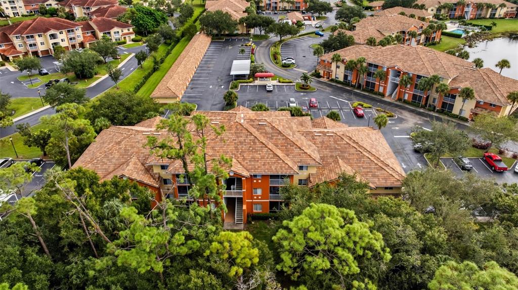 6401 Aragon Way, Unit 103 Fort Myers, FL 33966 - Photo 35 of 40 an aerial view of a house with a garden and trees