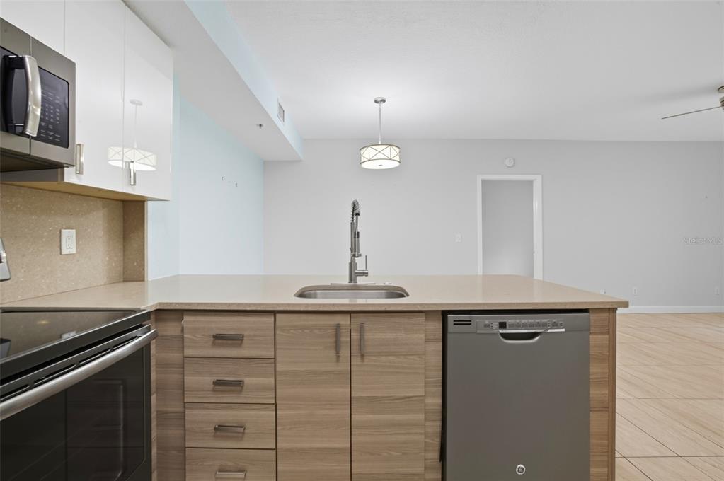 6401 Aragon Way, Unit 103 Fort Myers, FL 33966 - Photo 5 of 40 a kitchen with cabinets appliances and a counter space