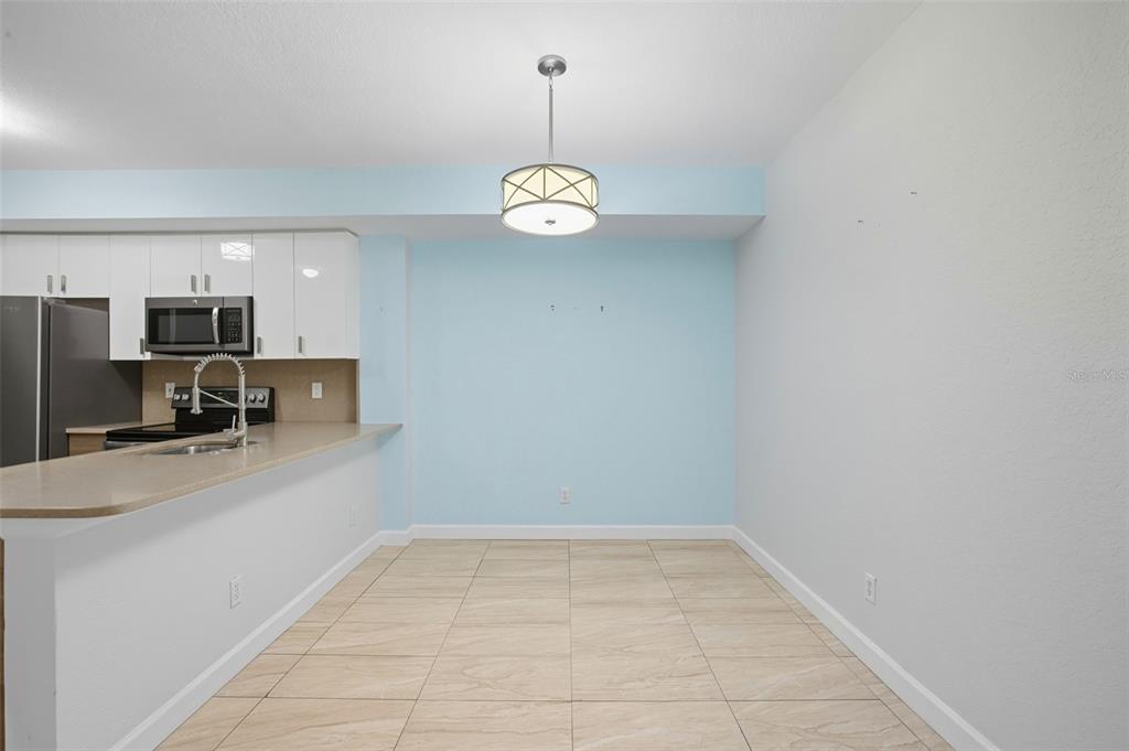 6401 Aragon Way, Unit 103 Fort Myers, FL 33966 - Photo 7 of 40 a view of a kitchen with a sink a refrigerator freezer and a dishwasher