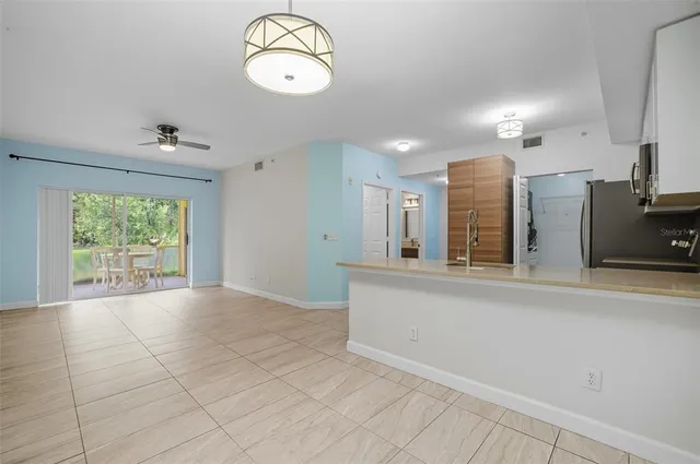 a view of kitchen with cabinet and refrigerator