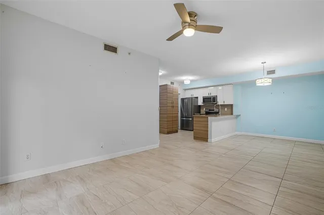a living room with furniture a ceiling fan and a rug