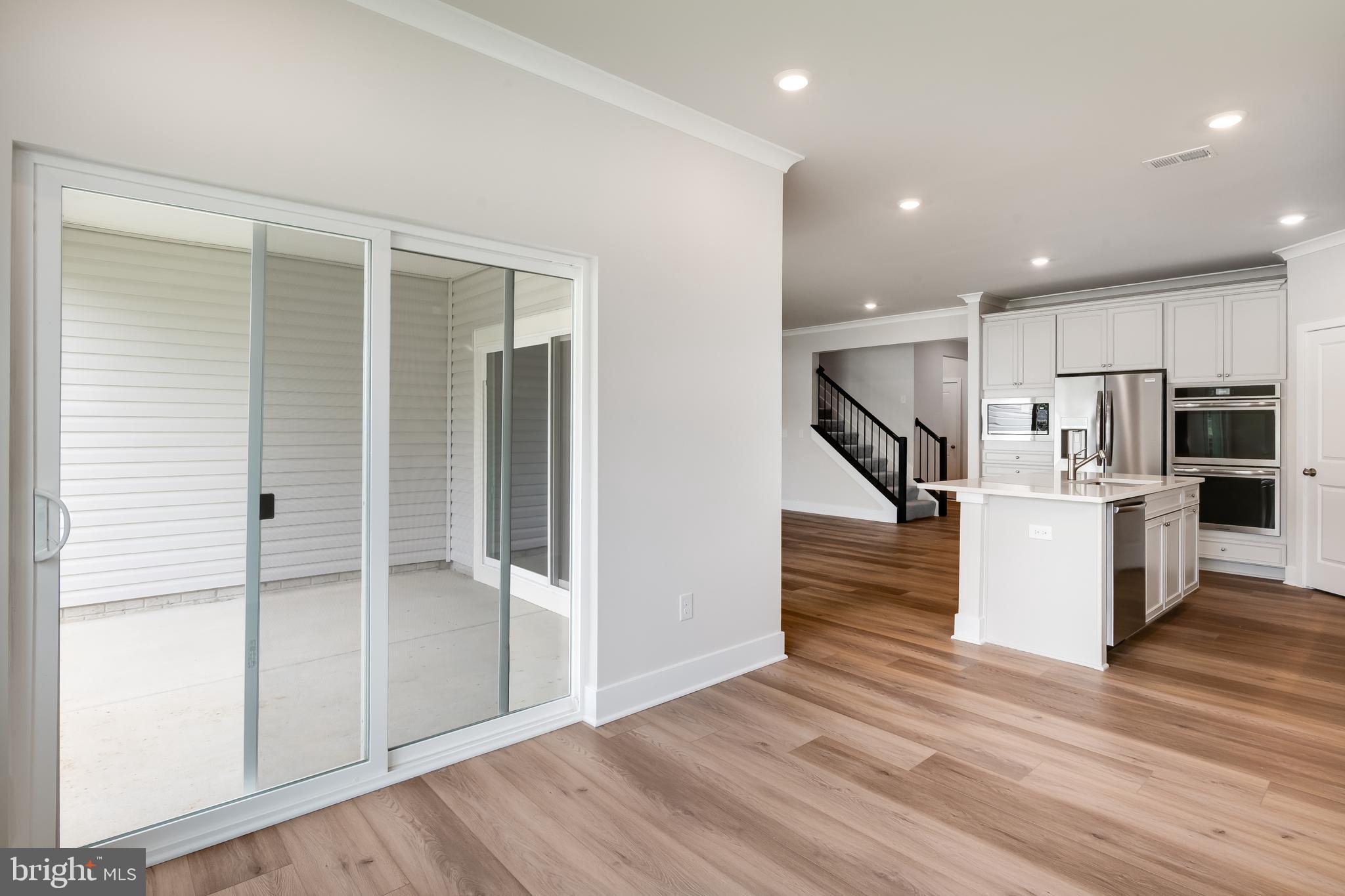 207 Mariners Circle Milton, DE 19968 - Photo 16 of 42 a view of kitchen with refrigerator and wooden floor