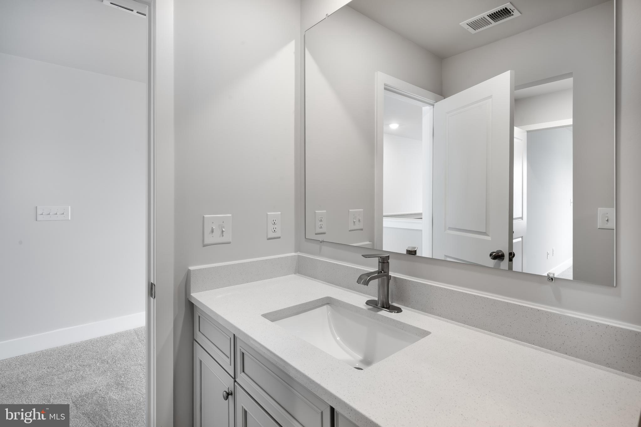 207 Mariners Circle Milton, DE 19968 - Photo 20 of 42 a bathroom with a sink and a mirror