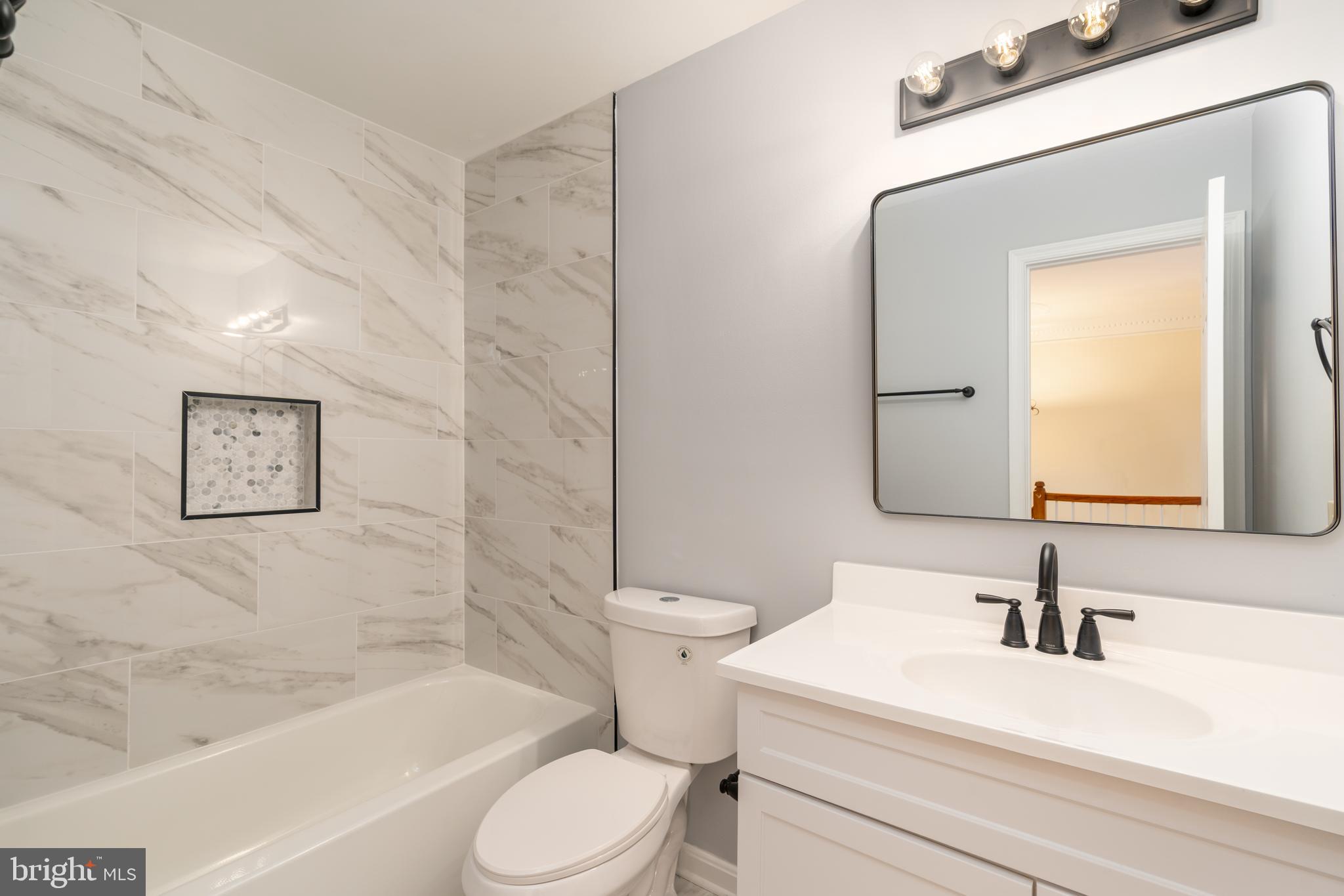 8010 Merry Oaks Lane Vienna, VA 22182 - Photo 21 of 33 a bathroom with a sink a toilet and a bathtub
