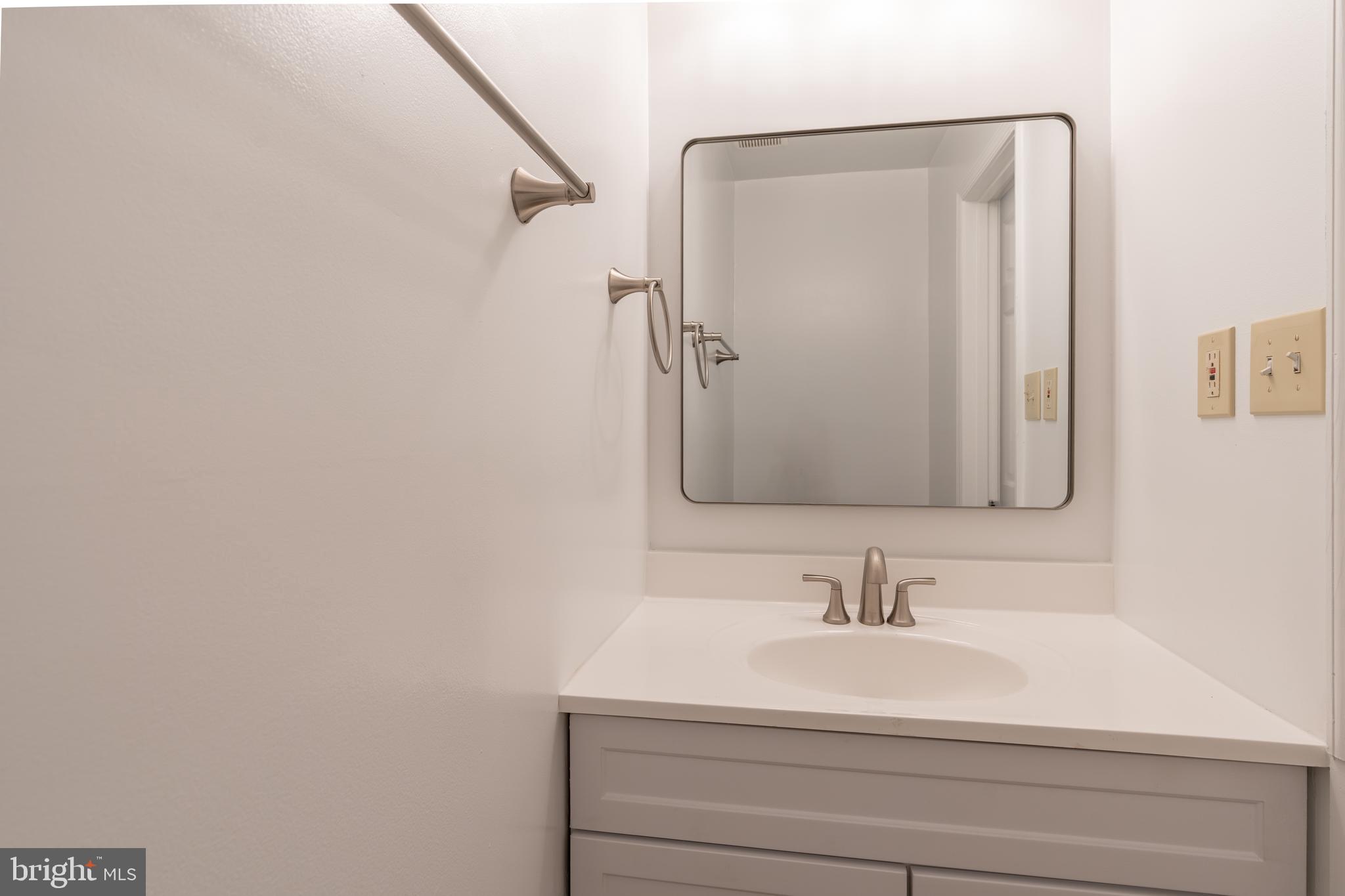 8010 Merry Oaks Lane Vienna, VA 22182 - Photo 29 of 33 a bathroom with a sink and a mirror