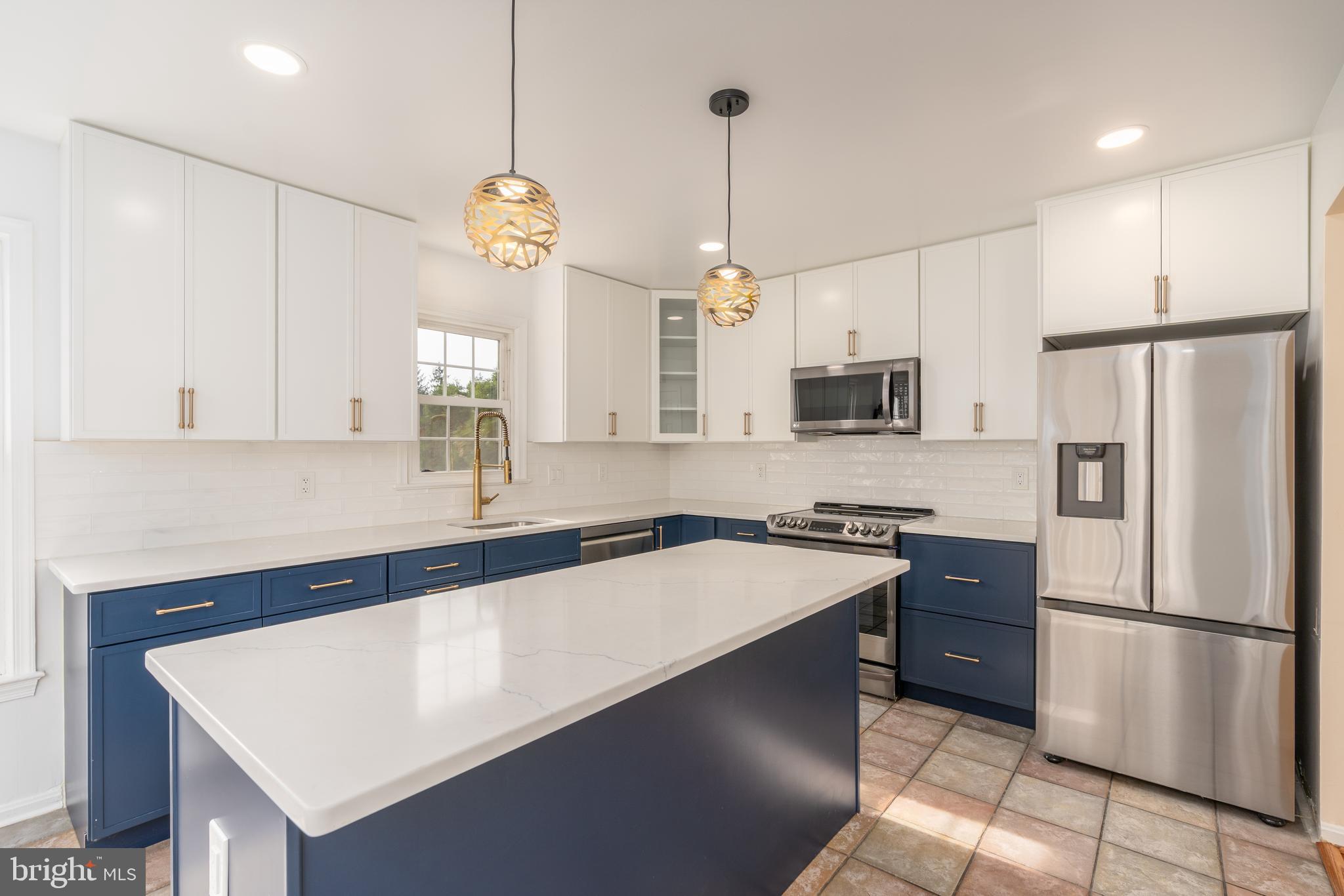 8010 Merry Oaks Lane Vienna, VA 22182 - Photo 4 of 33 a kitchen with stainless steel appliances a refrigerator sink and microwave