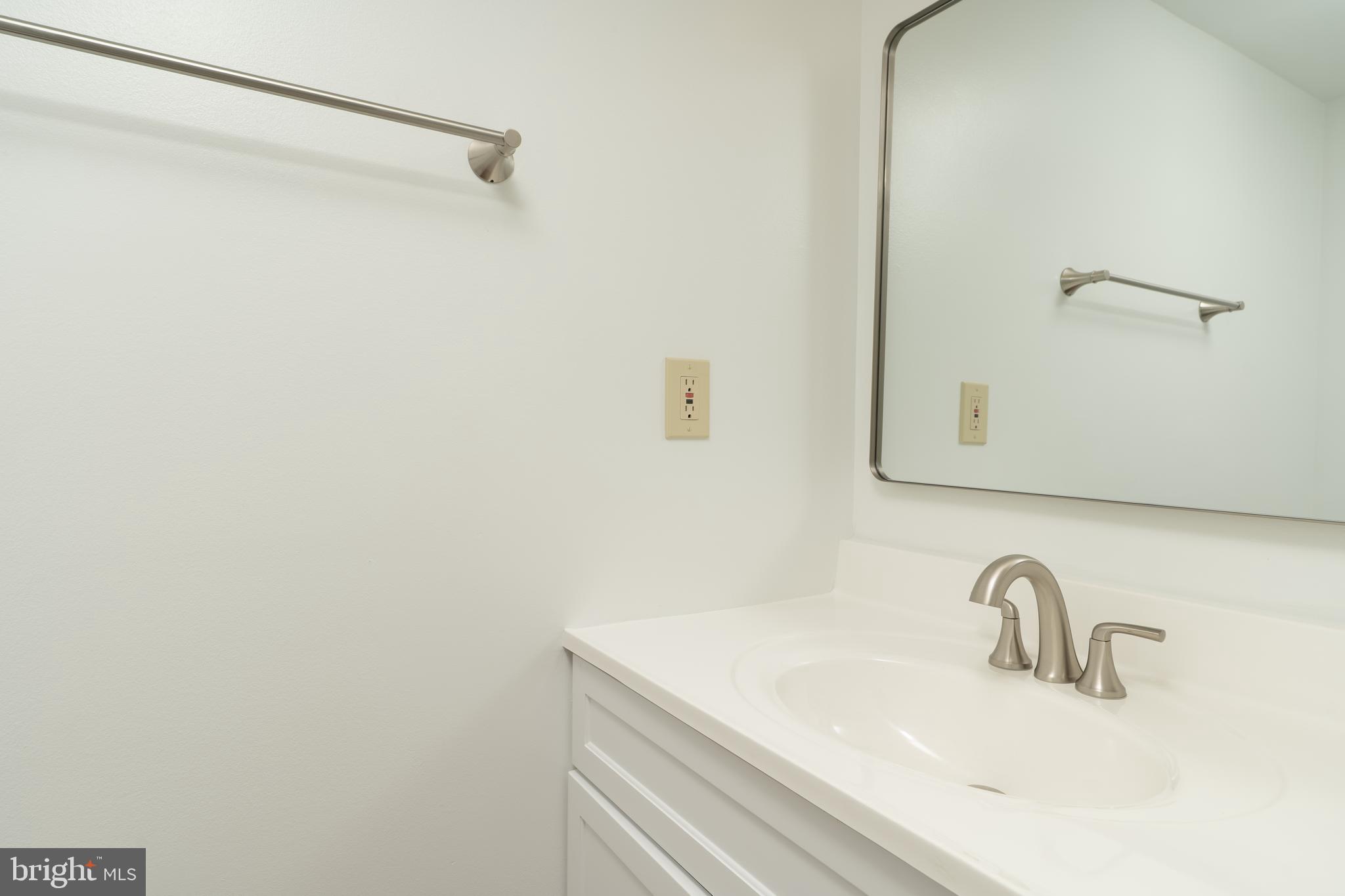 8010 Merry Oaks Lane Vienna, VA 22182 - Photo 8 of 33 a bathroom with a sink and a mirror