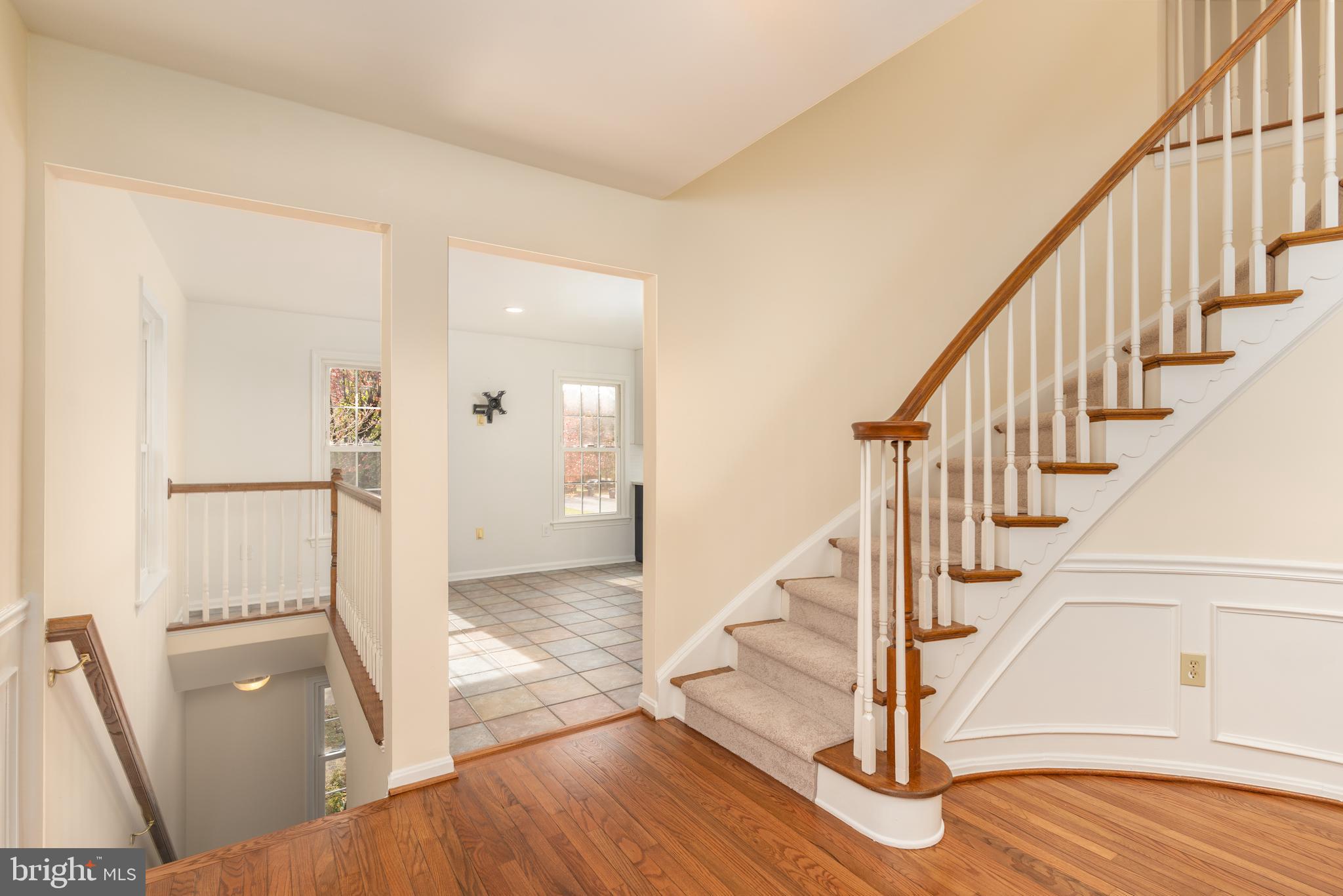8010 Merry Oaks Lane Vienna, VA 22182 - Photo 9 of 33 a view of an entryway with wooden floor and staircase