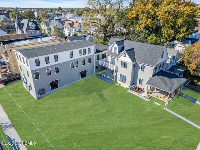 a view of a house with a big yard and large trees