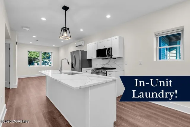 a view of kitchen island with furniture wooden floor and windows
