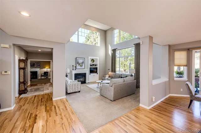 a spacious bedroom with a bed a chandelier and a television