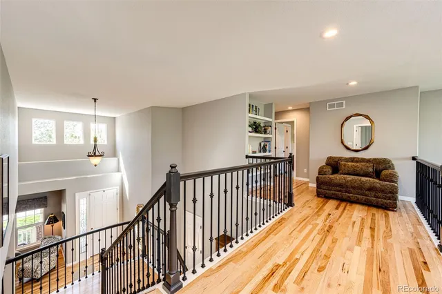 a spacious bathroom with a granite countertop sink and a mirror