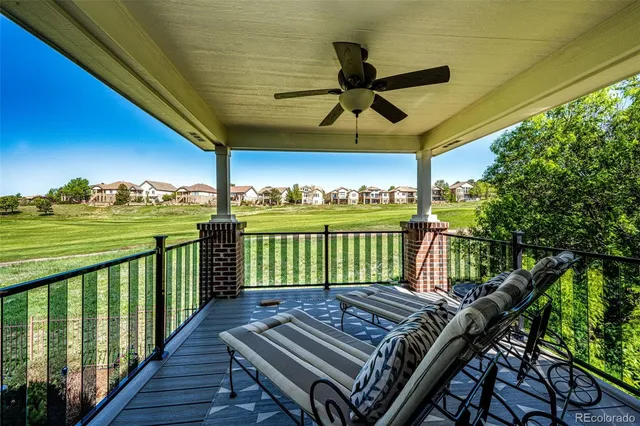 a bedroom with a large bed and a chandelier fan