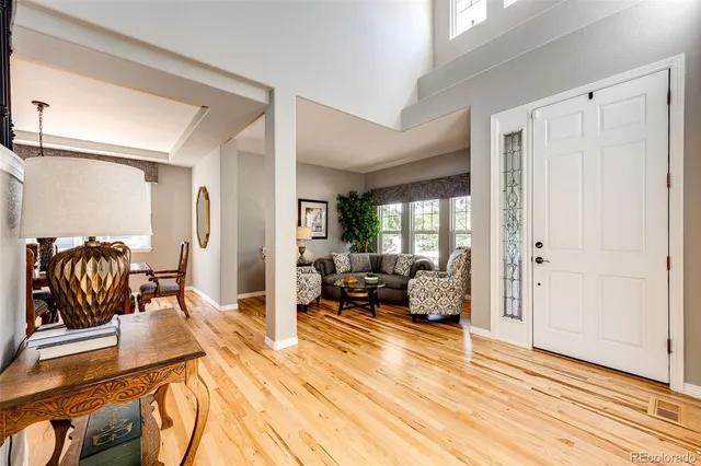 a large living room with stainless steel appliances granite countertop a couch and wooden floor