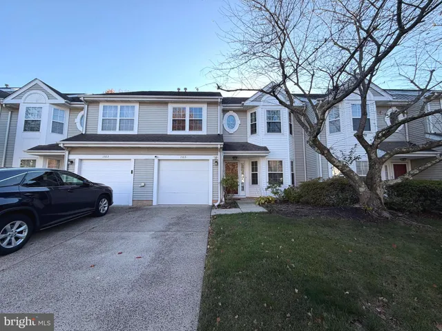 a car parked in front of a white house