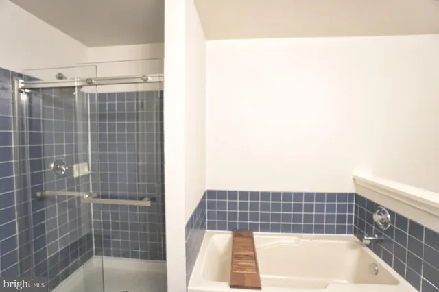 a bathroom with a bathtub and shower