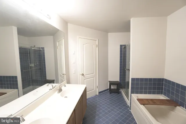 a bathroom with a tub sink and shower
