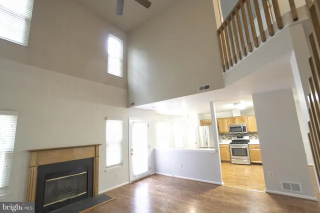 a view of a living room with furniture and a fireplace