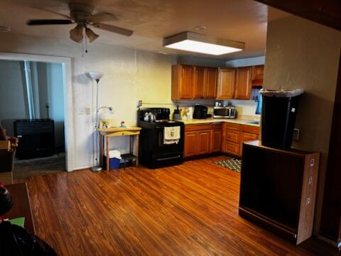 1785 Brigman Street Anderson, CA 96007 - Photo 4 of 13 a kitchen with stainless steel appliances kitchen island granite countertop a refrigerator a stove and a sink with wooden floor