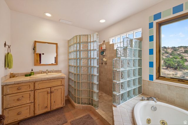 3617 Red Rock Drive Moab, UT 84532 - Photo 56 of 79 Bathroom featuring vanity, walk in shower, a jetted tub, light tile patterned flooring, and recessed lighting