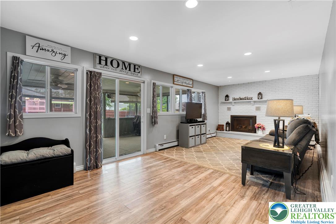 3340 Bridlepath Road Easton, PA 18045 - Photo 22 of 52 a living room with furniture a flat screen tv and a fireplace