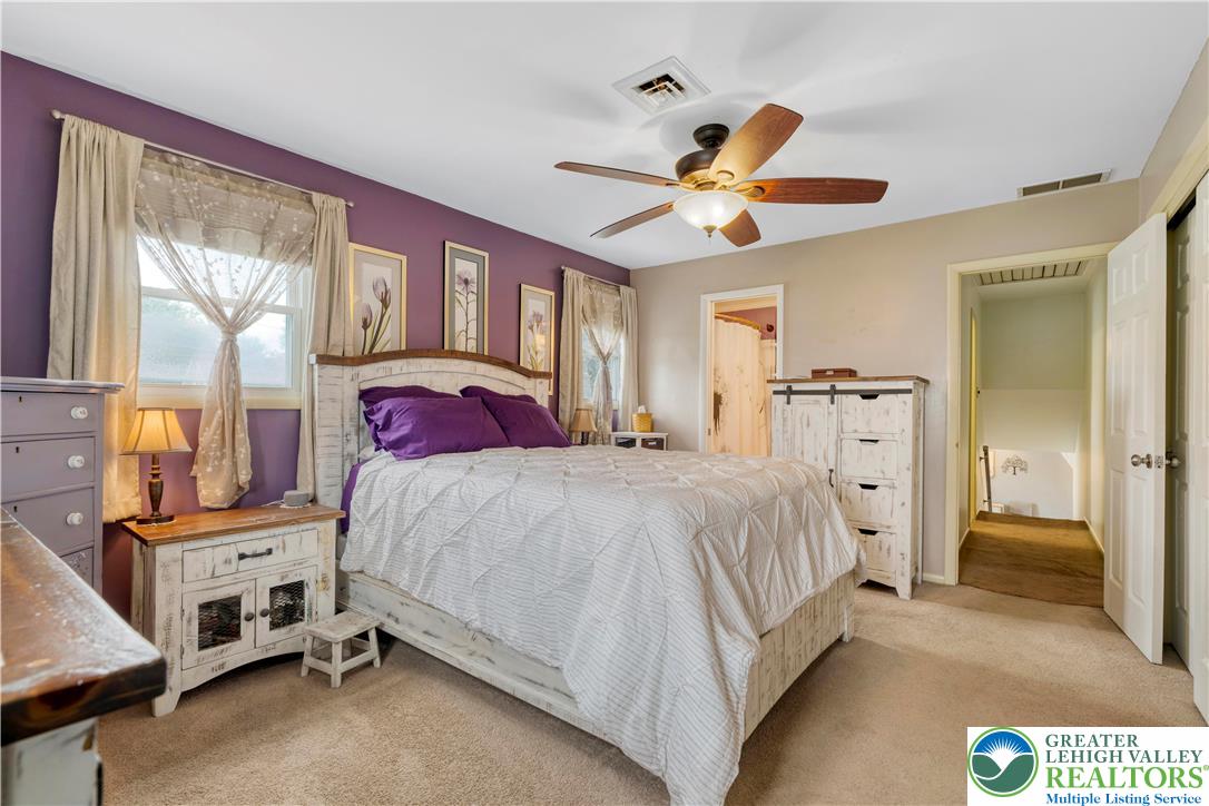 3340 Bridlepath Road Easton, PA 18045 - Photo 40 of 52 a bedroom with a bed and a chandelier