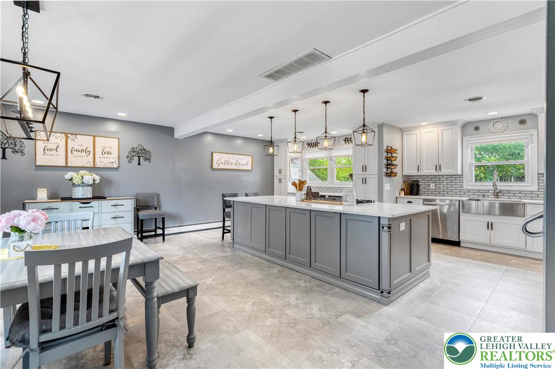 3340 Bridlepath Road Easton, PA 18045 - Photo 9 of 52 a kitchen with stainless steel appliances kitchen island granite countertop a table chairs and a refrigerator